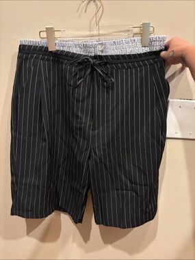 Fashion Nova Black Pinstripe Bermuda Shorts that are double lined in the waist.